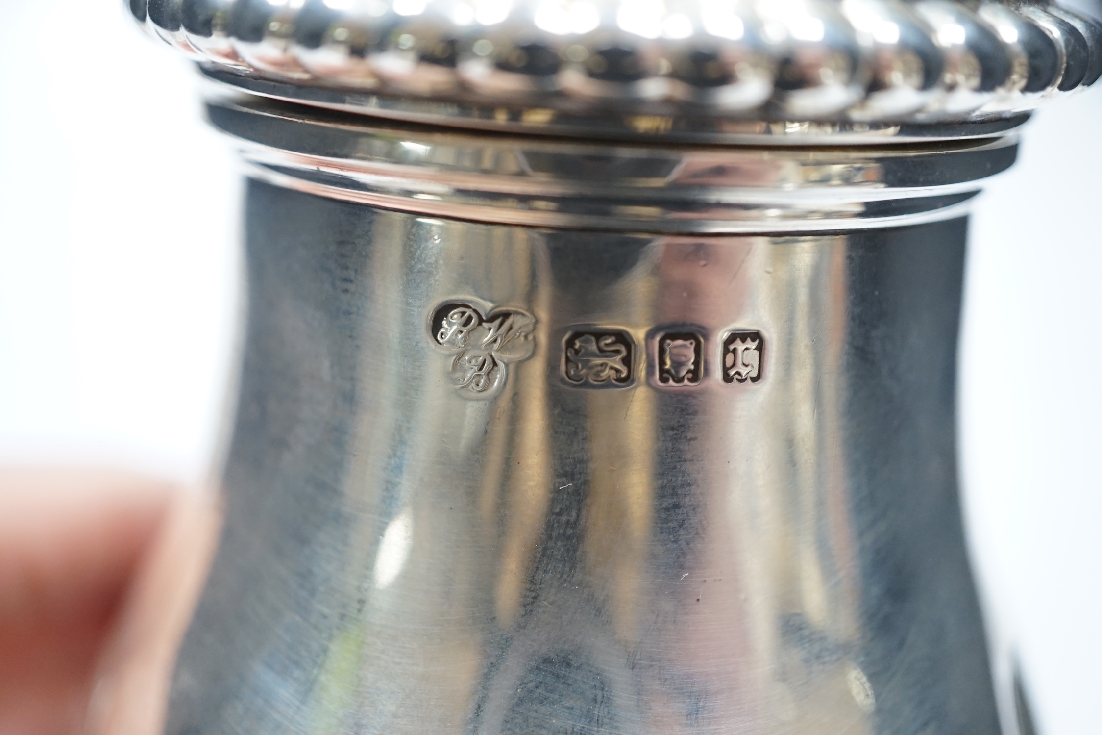 A George V silver baluster sugar caster, Harrod's Ltd, London, 1931, 20.2cm, 9.8oz.